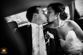In Northern California, specifically San Francisco, the newlyweds share an intimate kiss in the back of a limousine, captured in a romantic black-and-white photograph.